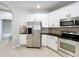 Well-equipped kitchen with stainless steel appliances, tile backsplash, and ample cabinet space at 1404 Lexington Avenue, Davenport, FL 33837