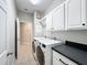 Clean laundry room, washer, dryer, cabinets and counter space at 1404 Lexington Avenue, Davenport, FL 33837