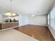 Open concept living space with hardwood floors, a ceiling fan, and an adjacent kitchen area at 1404 Lexington Avenue, Davenport, FL 33837