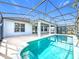 Screened-in pool with a view of the home's rear facade featuring pillars and large sliding glass doors at 1404 Lexington Avenue, Davenport, FL 33837