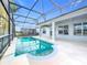 Refreshing pool area with screened enclosure and covered patio, perfect for outdoor relaxation at 1404 Lexington Avenue, Davenport, FL 33837
