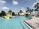 Gathering-friendly pool area with splash pad, water slides, sun loungers and lush landscaping at 1404 Lexington Avenue, Davenport, FL 33837