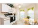 Cozy kitchen featuring white cabinetry, modern appliances, and an adjacent breakfast nook at 143 Hollingshead Loop, Davenport, FL 33896