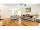 Bright living room featuring hardwood floors and neutral décor, perfect for relaxing at 143 Hollingshead Loop, Davenport, FL 33896