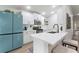 Modern kitchen with white cabinets and a quartz countertop island at 157 Del Sol Ave, Davenport, FL 33837