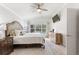 Bright main bedroom with king-size bed and access to the pool area at 157 Del Sol Ave, Davenport, FL 33837