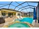 Relaxing screened pool and spa with patio furniture and a covered lanai at 157 Del Sol Ave, Davenport, FL 33837