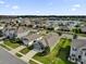 Aerial view of the community homes surrounding the pond, trees, and lush green lawns at 1813 Castleton Dr, St Cloud, FL 34771