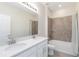Bright bathroom featuring double sinks, soaking tub/shower combo, and a large mirror at 1813 Castleton Dr, St Cloud, FL 34771