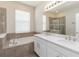 Primary bath featuring double vanity, soaking tub and glass enclosed shower at 1813 Castleton Dr, St Cloud, FL 34771