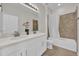 Bright bathroom features double vanity, framed mirrors, and tub with shower at 1813 Castleton Dr, St Cloud, FL 34771