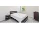 Simply furnished bedroom featuring neutral walls, gray carpet, a window, and minimalist furniture at 1813 Castleton Dr, St Cloud, FL 34771