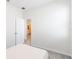 Minimalist bedroom featuring neutral walls, gray carpet, a window, and a doorway to the bath at 1813 Castleton Dr, St Cloud, FL 34771