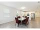 Open floor plan with a dining area leading into a modern kitchen with white cabinetry at 1813 Castleton Dr, St Cloud, FL 34771