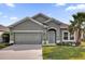Inviting single-story home with a two-car garage, well-manicured lawn, and appealing curb appeal at 1813 Castleton Dr, St Cloud, FL 34771