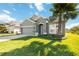 Charming single-story home with a well-maintained lawn, mature palm tree and manicured landscaping at 1813 Castleton Dr, St Cloud, FL 34771