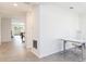Hallway with tile flooring leading to an open concept living area, promoting seamless flow and connectivity at 1813 Castleton Dr, St Cloud, FL 34771