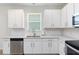 Modern kitchen featuring white cabinetry, stainless steel appliances, and bright, natural light at 1813 Castleton Dr, St Cloud, FL 34771