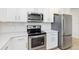 Well-equipped kitchen with stainless steel appliances, subway tile backsplash, and quartz countertops at 1813 Castleton Dr, St Cloud, FL 34771