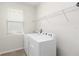 Bright laundry room featuring a window, wire shelf, and modern washer and dryer at 1813 Castleton Dr, St Cloud, FL 34771