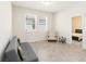 Cozy bonus room with two windows, neutral paint, tile floors, and simple furnishings at 1813 Castleton Dr, St Cloud, FL 34771