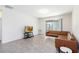 Inviting living area with comfortable seating, tile floors, and sliding glass door access at 1813 Castleton Dr, St Cloud, FL 34771