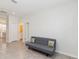 Bright living room featuring neutral walls, tile floors, and a gray sofa at 1813 Castleton Dr, St Cloud, FL 34771