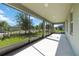 Covered patio with screened windows overlooks the manicured lawn and landscaped street at 1813 Castleton Dr, St Cloud, FL 34771