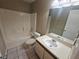 Clean bathroom with a bathtub, toilet and vanity with sink at 2024 Trinidad Ct, Kissimmee, FL 34741