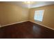 Bright bedroom with dark laminate wood flooring at 2024 Trinidad Ct, Kissimmee, FL 34741