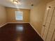 Simple bedroom with dark laminate wood flooring at 2024 Trinidad Ct, Kissimmee, FL 34741
