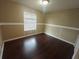 Bright bedroom with dark laminate flooring and window coverings at 2024 Trinidad Ct, Kissimmee, FL 34741