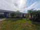 Exterior view of condo,landscaped lawn, and palm trees at 2024 Trinidad Ct, Kissimmee, FL 34741