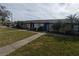 Two-story building exterior with landscaping and walkway at 2024 Trinidad Ct, Kissimmee, FL 34741