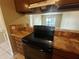Condo kitchen with brown cabinets and black appliances at 2024 Trinidad Ct, Kissimmee, FL 34741