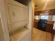 Condo laundry closet with stacked washer and dryer at 2024 Trinidad Ct, Kissimmee, FL 34741