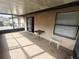 Cozy screened porch with small table and window at 2024 Trinidad Ct, Kissimmee, FL 34741