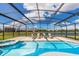 Spacious screened pool area with lounge chairs and a spa at 2281 Crofton Ave, Davenport, FL 33837