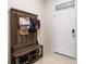 Functional entryway features a built-in storage bench and coat rack for organizing essentials at 2352 Tay Wes Dr, St Cloud, FL 34771