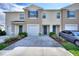 Inviting townhouse exterior with well-manicured landscaping and private driveway at 2352 Tay Wes Dr, St Cloud, FL 34771