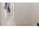 Hallway showcasing access to a dining area with natural light and sleek tile flooring at 2352 Tay Wes Dr, St Cloud, FL 34771
