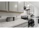 Modern kitchen features gray cabinets and stainless appliances for a sleek and stylish design at 2352 Tay Wes Dr, St Cloud, FL 34771