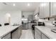 Contemporary kitchen featuring stainless steel appliances, grey cabinets, and ample counter space at 2352 Tay Wes Dr, St Cloud, FL 34771