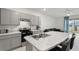 Modern kitchen featuring stainless steel appliances, gray cabinets, and an island at 2352 Tay Wes Dr, St Cloud, FL 34771