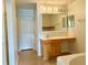 Main bathroom boasts wood cabinets and a large vanity at 2403 Melissa Ann Ct, Kissimmee, FL 34746