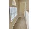Bright hallway with carpet, window, and door to bedroom at 2403 Melissa Ann Ct, Kissimmee, FL 34746