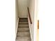 Carpeted staircase with a wooden handrail at 2403 Melissa Ann Ct, Kissimmee, FL 34746