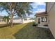 Spacious backyard with grassy area and mature tree, offering privacy at 2542 Bobby Lee Ln, St Cloud, FL 34772