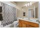 Clean bathroom with shower/tub combo, toilet and vanity with wood cabinets at 2542 Bobby Lee Ln, St Cloud, FL 34772