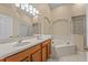 Bathroom with double vanity, garden tub, and separate shower at 2542 Bobby Lee Ln, St Cloud, FL 34772